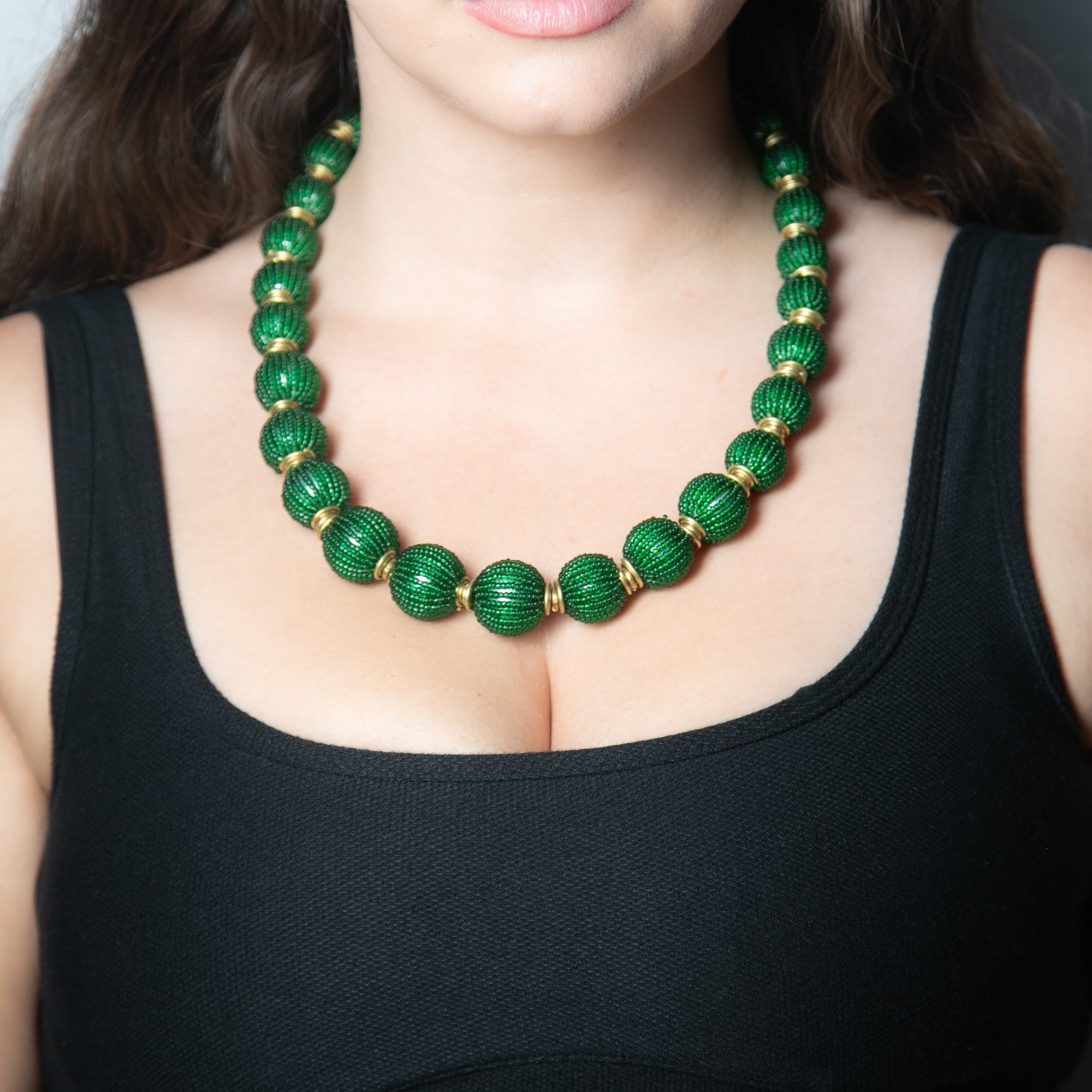 Handcrafted beaded ball necklace featuring vibrant beads and gold-toned accents, elegantly designed for a stylish and unique look.