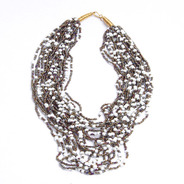 Strung with 20 individual strands of glass seed beads to create this cascading splash of color. The various bead sizes give the Lani an interesting texture that will turn heads every time you wear it. Pair it with a white t-shirt and jeans for an effortless look.