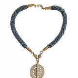 With gorgeous blue beads reminiscent of the ocean. This stunning Mila beaded necklace perfectly combined with a brass baule bead is unique and one-of-a-kind. Get ready to make a show stopping statement.