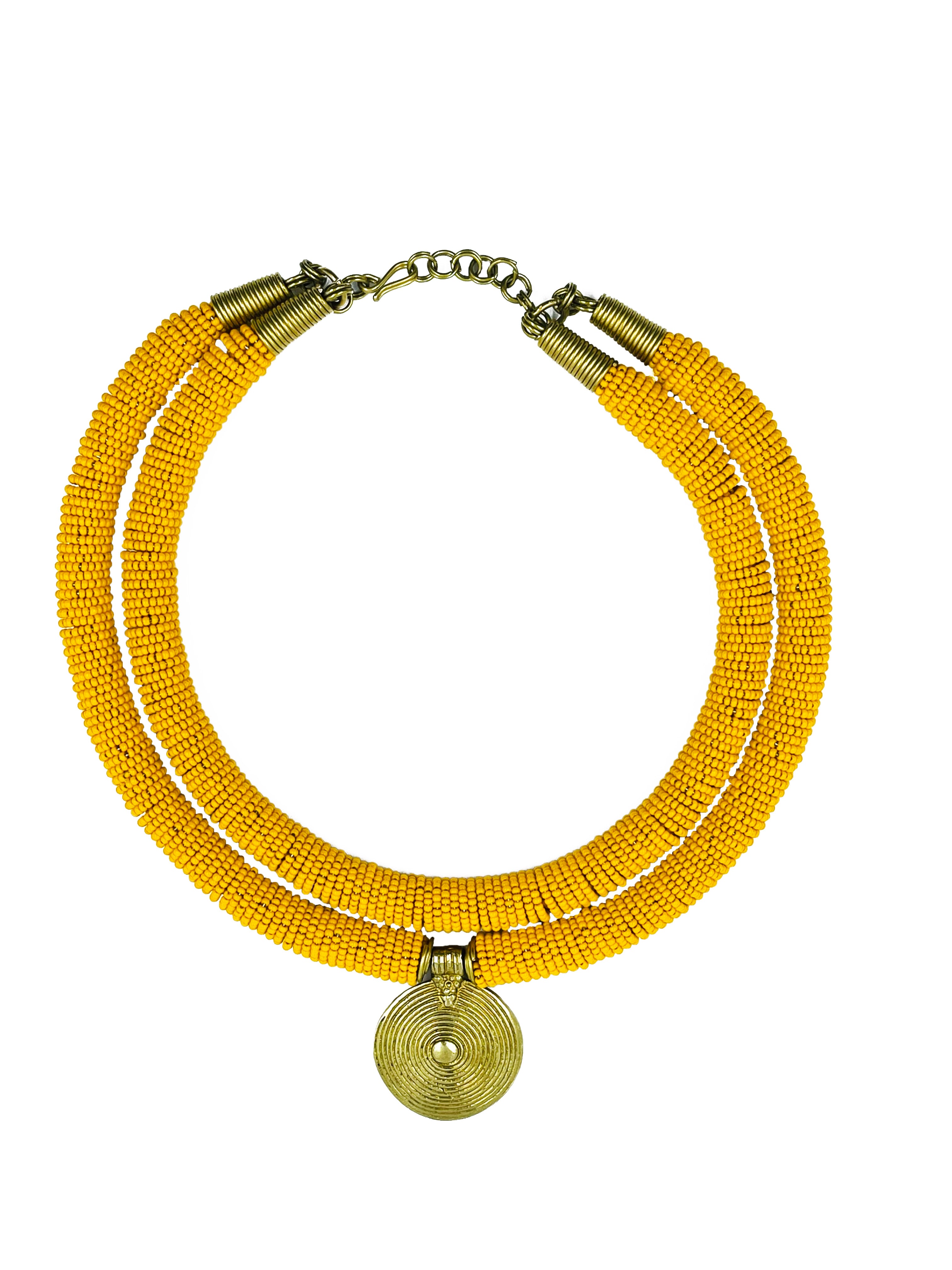Aje is a stunning necklace showcasing African artistry's essence. The necklace features an eight-inch strand of handcrafted glass beads sourced locally in Africa