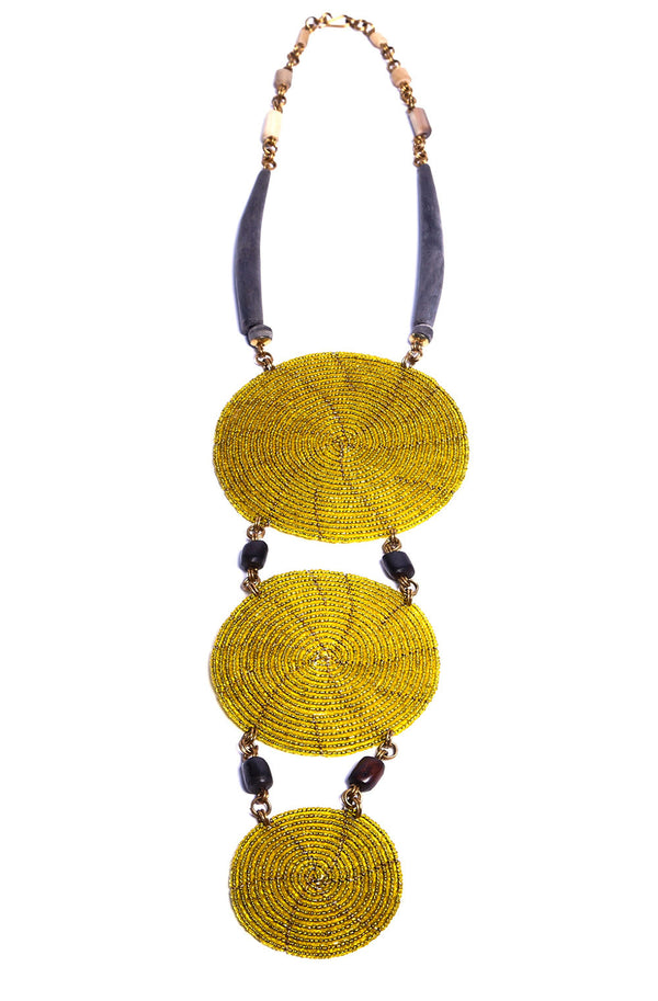 This stunning one-of-a-kind necklace features hundreds of yellow glass beads each individually placed by hand, giving it a bold and striking design. Get lots of compliments on this unique and bold statement necklace.