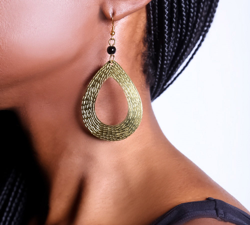 Striking tear-drop brass earrings. Handcrafted with care and attention to detail, these earrings will add a special touch of style and flair to your look.