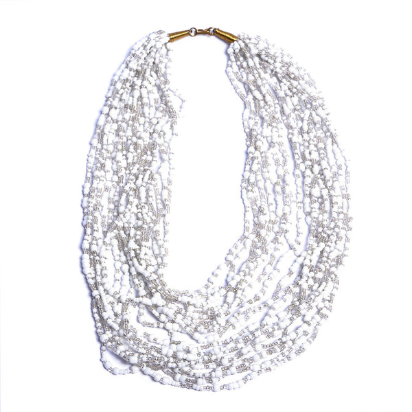 Strung with 20 individual strands of glass seed beads to create this cascading splash of color. The various bead sizes give the Lani an interesting texture that will turn heads every time you wear it. Pair it with a white t-shirt and jeans for an effortless look.