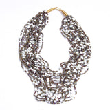 Strung with 20 individual strands of glass seed beads to create this cascading splash of color. The various bead sizes give the Lani an interesting texture that will turn heads every time you wear it. Pair it with a white t-shirt and jeans for an effortless look.